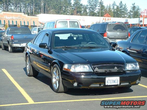 Black 2000 Ford Crown Victoria parked in a lot, front quarter view