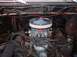 1979 Ford Bronco - Close-up view of an engine bay, focusing on the carburetor and air intake system.