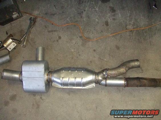 Exhaust system part with catalytic converter and muffler