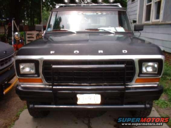 Front view of a black 1979 Ford Bronco with a grille guard and roof lights