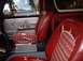 1979 Ford Bronco - Interior view of a 1979 Ford Bronco, red seats with striped inserts and a silver door panel.