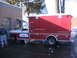 1984 Ford F-350 - This ambulance truck has a white cab and a large red body with storage compartments.
