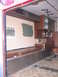 1984 Ford F-350 - The interior of a vehicle, possibly an ambulance or camper, is shown with brown seating and cabinetry, and a patch of green paint on the wa…