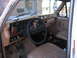 1984 Ford F-350 - The interior of a truck shows tan seats, a wood-grain dashboard, and a Ford steering wheel, with 'NO SMOKING' text visible.
