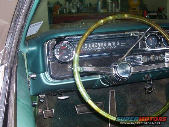 Green 1965 Pontiac Catalina interior dashboard with tachometer and speedometer