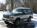 1994 Ford Bronco - Two-tone green and silver 1994 Ford Bronco in a snowy driveway.