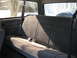 1994 Ford Bronco - Rear interior view of a 1994 Ford Bronco, showing the bench seat and a spare tire mounted behind it.