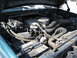 1994 Ford Bronco - Engine bay of a 1994 Ford Bronco, showing hoses, alternator, and other engine components under the hood.