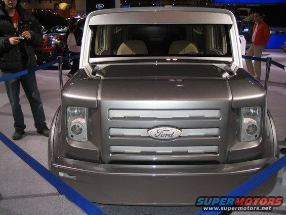 Silver Ford concept van front view with horizontal grille and large headlights