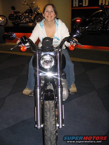 Woman sitting on a Harley-Davidson motorcycle, with another motorcycle behind her