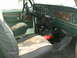 1979 Ford Bronco - The interior of a 1978 Ford Bronco shows camouflage seat covers and a fire extinguisher on the floor.