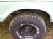 1979 Ford Bronco - Close-up of a light green SUV's rear wheel and fender, showing a Goodyear Wrangler tire and a date stamp from 2007.