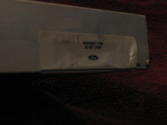 Part with Ford logo and warranty sticker
