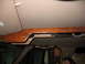 1995 Ford C-350 (Centurion Conversions) - Interior view of a vehicle's overhead console, showing wood grain trim and exposed wiring.