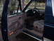1992 Ford Bronco - Interior view of a 1992 Ford Bronco with the driver's door open, showing the tan seats and dashboard.