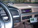 1992 Ford Bronco - The interior of a truck shows the dashboard with aftermarket stereo and GPS unit.