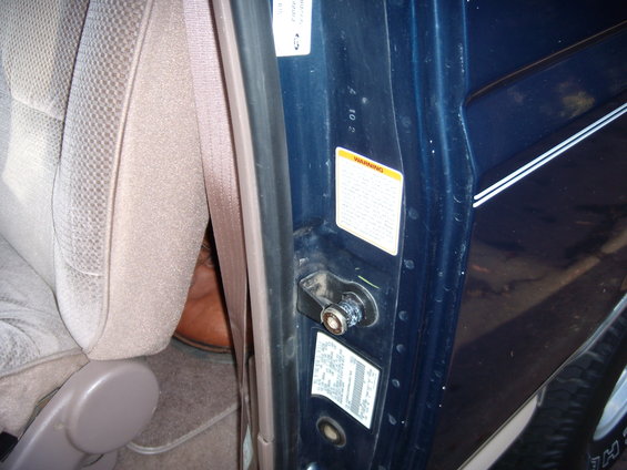 1992 Ford Bronco interior door jamb with warning stickers and beige seat