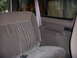 1992 Ford Bronco - Interior view of a vehicle's back seat and door panel, showing the seatbelt mechanism.