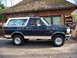 1992 Ford Bronco - Side profile of a 1992 Ford Bronco, a two-tone paint scheme and a roof rack.