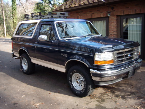1992 Ford Bronco, dark blue with tan trim, roof rack, parked outdoors