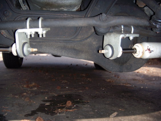 Undercarriage steering linkage and shock absorber assembly