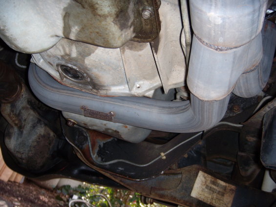 Exhaust pipe with a stamped metal tag