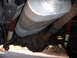 1992 Ford Bronco - Close-up of the undercarriage, focusing on the exhaust system and rear differential.