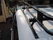 1992 Ford Bronco - A black roof rack system is mounted to the side of a white vehicle.