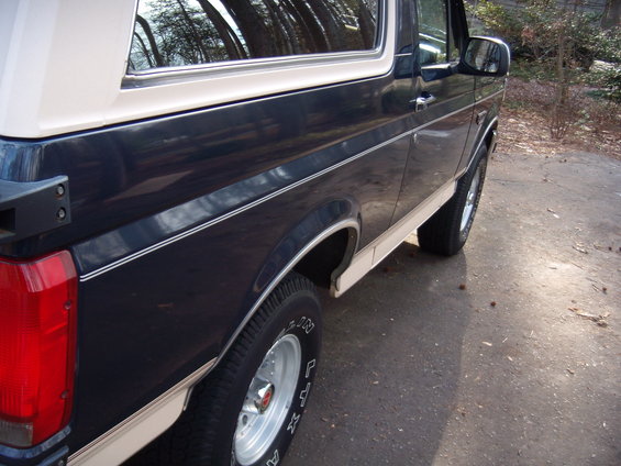 1992 Ford Bronco side view, dark blue and tan