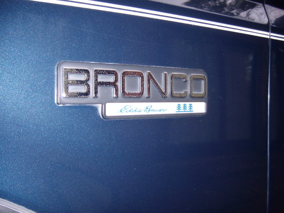 Blue Ford Bronco Eddie Bauer emblem on a dark blue vehicle
