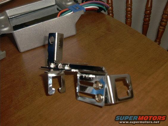 Chrome bracket with wires and a silver electronic component