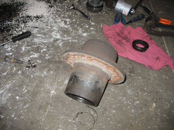 Brake drum and bearing on concrete floor with tools