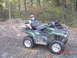 2005 Yamaha GRIZZLY 660 - A man poses on his Yamaha Grizzly ATV, having successfully hunted a deer.