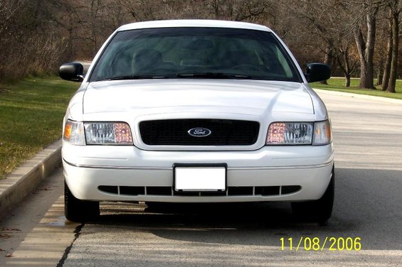 White 2003 Ford Crown Victoria parked on a road