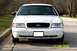 2003 Ford Crown Victoria - Front view of a white 2003 Ford Crown Victoria with a black grille and a blank license plate holder.