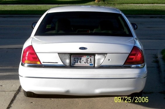 White sedan rear view. Wisconsin license plate 574-JEA