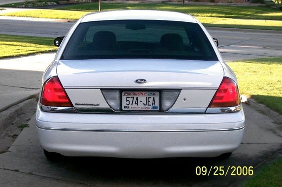 Rear view of a white 2003 Ford Crown Victoria with Wisconsin license plate 574-JEA