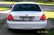 2003 Ford Crown Victoria - White 2003 Ford Crown Victoria parked on a driveway, showing its rear end and license plate.