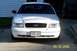 2003 Ford Crown Victoria - Front view of a white Ford Crown Victoria, parked on a concrete driveway. The date 09/25/2006 is visible.