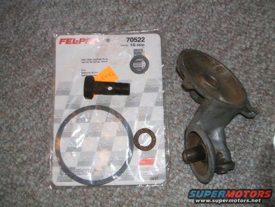 Oil filter housing and Fel-Pro gasket set with bolt and washer on carpet