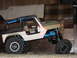 1984 Ford Bronco - This remote control rock crawler toy has a modified body with an exposed interior and a blue roll cage.