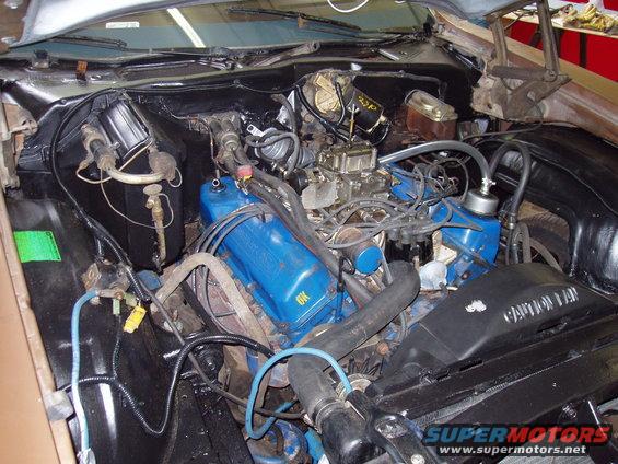 1972 Ford Ranchero engine bay with blue valve covers and carburetor