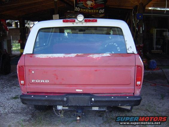 Rear view of a red and white 1978 Ford Bronco with a tow hitch