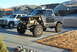 1986 Ford Bronco - This heavily modified SUV, likely from the 1980s, has had its front end stripped and features oversized off-road tires.