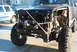 1986 Ford Bronco - This 1986 Ford Bronco features a custom front bumper and winch, with a white SUV visible in the background.