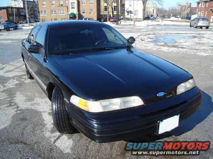 Black 1992 Ford Crown Victoria sedan, front quarter view, showing headlights, grille, and hood