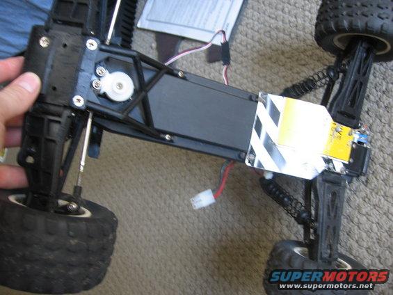 RC car chassis with suspension and wiring visible