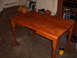 1988 Ford Bronco - A wooden dining table is shown in a garage setting, with a can of wood stain nearby.