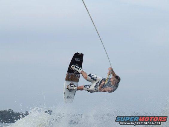 Wakeboarder performing a trick in the air over water