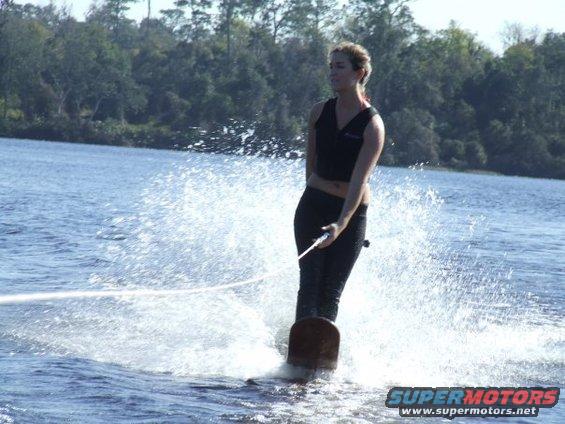 Woman waterskiing with a large splash
